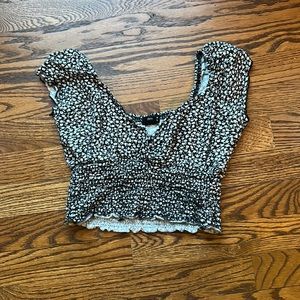Billabong crop top black floral cross over neck line.